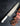 skware modern chef knife with white handle on slate countertop with sliced steak